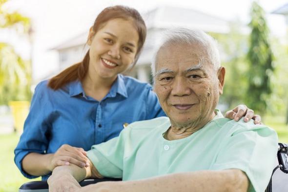 Healthcare recruitment in Wolverhampton. Young Asian woman comforting an elderly Asian man.